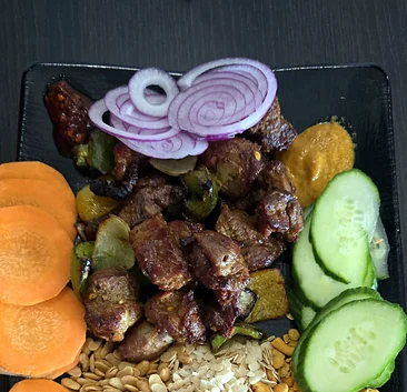 Grilled meat with onion and achar on a Nepali platter